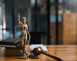 Image - Statue of lady justice on desk of a judge or lawyer.